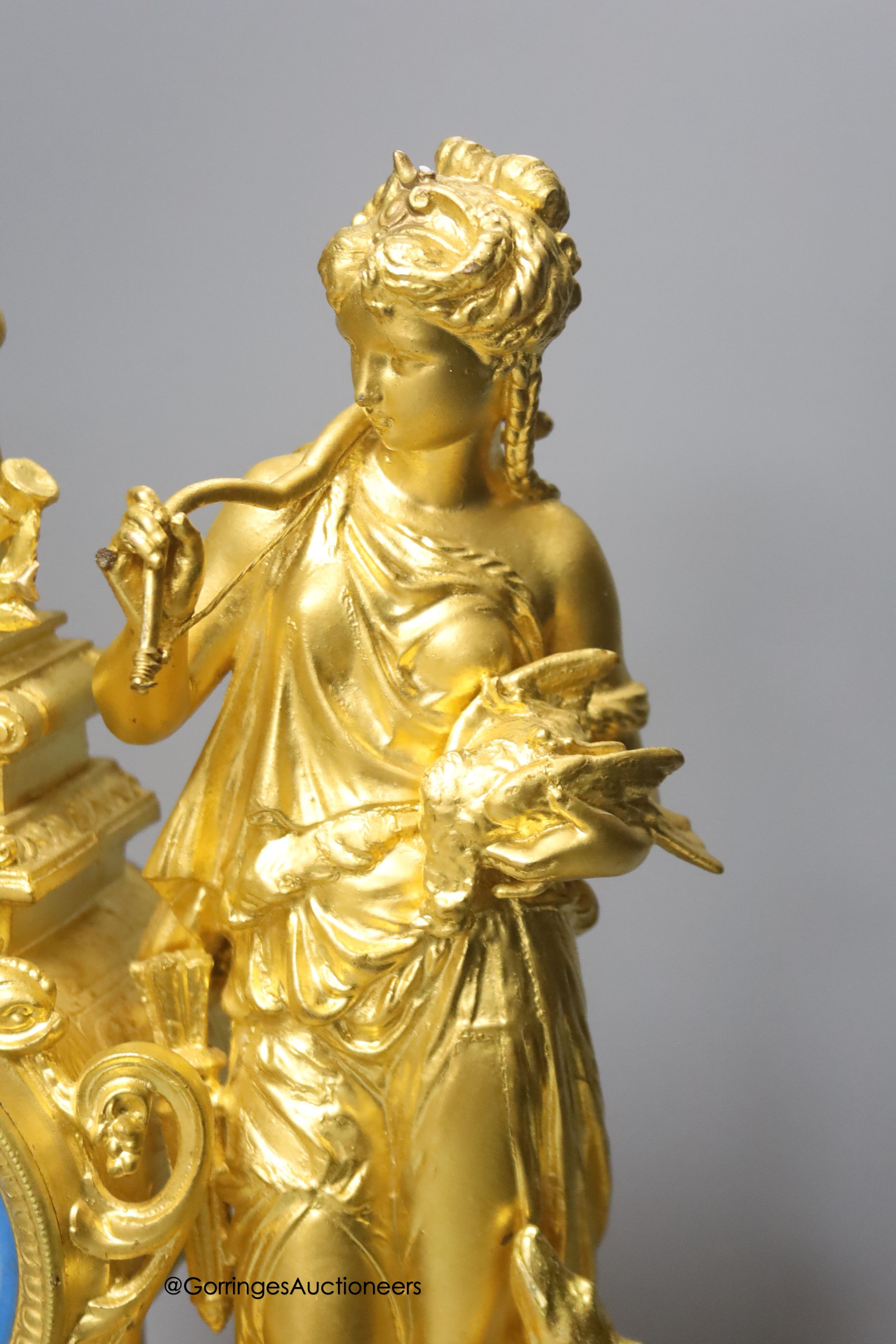 A late 19th century French gilt metal figural mantel clock, with Sevres style inserts, with key and pendulum, height 42cm